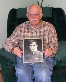 AT PEACE: Powell River Veteran Hayden Hughes holds a photograph of his brother the late Gordon Booth Hughes who was killed while training during World War II.